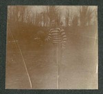 Photograph of unidentified Miami Military Institute cadet in football garb on a field, holding a football, 1904
