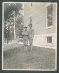 Photograph of Kleon Thaw Brown and another unidentified cadet, standing beside the Miami Military School building, 1905