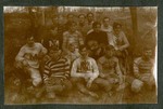 Photograph depicting a group of young men from Miami Military Institute in football garb, seated on the ground, 1904