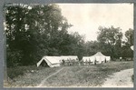 Photo of Miami Military Institute cadets in uniform beside tent encampment, 1900