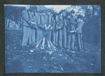 Photograph from scrapbook page, depicting Miami Military Institute cadets standing near a fire, 1904