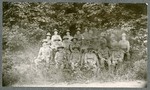 Photo of Miami Military Institute cadets in uniform, seated, in a wooded area, 1900
