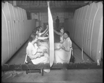 Female employees work on a wing section while military personnel watch at the Dayton-Wright Airplane Company by The Dayton-Wright Airplane Company