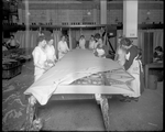Female employees of the Dayton-Wright Airplane Company attach fabric to the skeleton of a De Havilland DH-4 wing at the Cloth Assembly Department by The Dayton-Wright Airplane Company