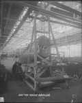 Employees of the Dayton-Wright Airplane Company remove the landing gear from a De Havilland DH-4 by The Dayton-Wright Airplane Company