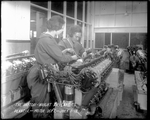 Two female employees work on a Liberty Engine in the Motor Department of the Dayton-Wright Airplane Company Plant 1 July 1, 1918 by The Dayton-Wright Airplane Company