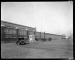Early automobiles parked outside of a Dayton-Wright Airplane Company factory by The Dayton-Wright Airplane Company