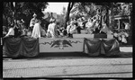 The parade Queen, Helen B. Fishter, holding the first airplane, during the 1909 Wright Brothers Homecoming Celebration