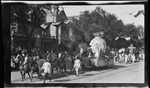 A parade float, featuring a globe supporting the Wright Flyer, during the 1909 Wright Brothers Homecoming Celebration by Andrew S. Iddings