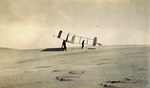Profile view of men carrying Wright 1911 Glider