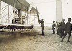 Wilbur Wright cranking a propeller