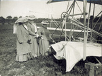 Three ladies examine the damaged Wright Model A Flyer