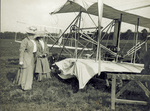 Two ladies examining the damaged Wright 1907 Flyer