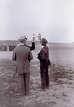 Two men holding anemometers