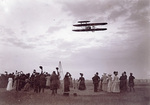 Spectators wave their hats to Orville Wright