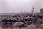 Spectators with umbrellas