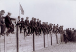 Spectators sitting of fences