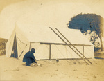 Wilbur Wright cleaning a pan with sand by Orville Wright