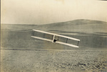 Wilbur Wright banking right in the 1902 glider