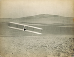 Wilbur Wright banking right in the Wright 1902 glider