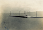 Orville Wright landing the Wright 1902 glider by Wright Brothers