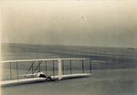 Wilbur Wright landing the Wright 1902 glider by Wright Brothers