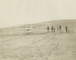 Four men, two boys, a dog, and a flying machine by Wright Brothers