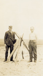 William Tate and Elijah Tate with scrap wood marker
