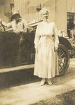 Katharine Wright standing with a friend seated in an automobile