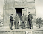 Group standing in front of Wright Memorial under construction