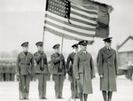 Major Kepner and Captain Stevens stand in front of color guard