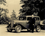 Orville Wright standing next to new Hudson automobile