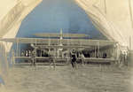 Wright Model A Flyer being pulled from tent by C. H. Claudy