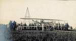 Wright Model A Flyer on launch rail surrounded by spectators by C. H. Claudy
