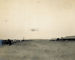 Wright Model A Flyer in flight above parade ground