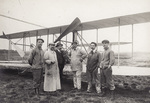 Rene Pellier and Wilbur Wright's mechanics standing in front of the Wright Flyer