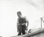 Earle Ovington standing in a monoplane at the Harvard-Boston Aero Meet, August - September, 1911
