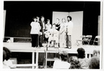 Students singing with staff member