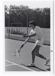 Student hitting tennis ball