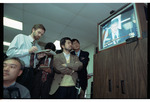 Members of the Press Watching President Clinton on a TV at the Signing of the Dayton Peace Agreement by Dayton Daily News and Jan Underwood