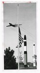 A Boeing C-135 Stratolifter Flying Past a Flag at Half Mast by Dayton Daily News and Bill Shepherd