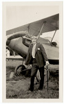 Man with cane standing by plane