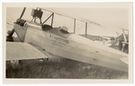 3/4 view of biplane in field